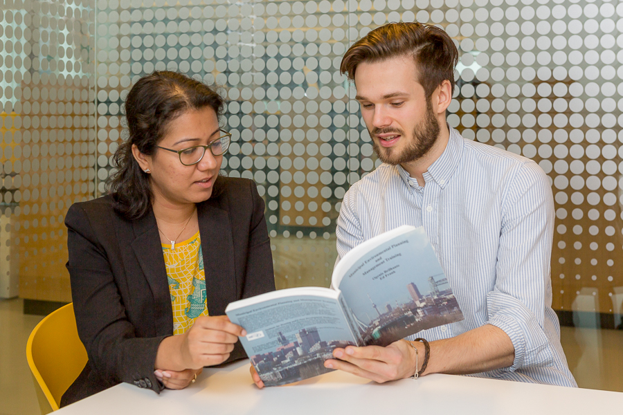 Two students looking at a book