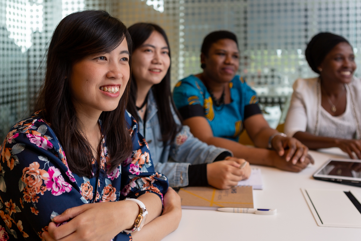 Four students sitting together and listening to a lecture
