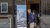 Attendee in front of the event banner, on arrival