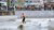 Man surfing while people watch