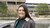 Photo of Claire Wastell standing by the pond at EUR campus
