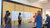 Group of people looking at poster