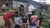 Dakota and his peers handing out porridge in Mathare