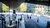 People walking around Rotterdam Centraal station in urban setting with trees