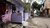 Purple house with striped lower wall on a narrow street with bicycle parked outside