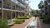 Courtyard walkway with shallow glass-bottom water channel between apartment balconies