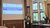 Presenter speaking at podium in large, wood-paneled room with scholarship slide projected