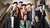 Eight people stand together on a staircase, smiling at the camera after a PhD defence. The PhD researcher stands in the centre, surrounded by members of the examination committee and other attendees.