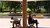 A man and woman sit on benches taking shade from the sun during a heatwave
