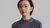 woman with short hair and gray sweater