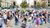 blurred crowd of pedestrians crossing a busy city intersection with historic buildings