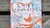 Book cover showing orange koi fish and blue line-drawn Chinese village scene on white background
