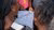 People outdoors examining a blue urban map with handwritten notes and sketches