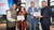 professionals holding an award certificate and smiling